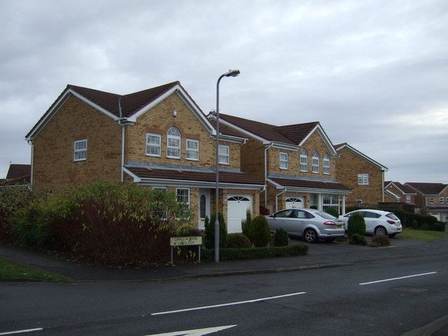 Detached brick houses with driveways on Challacombe Crescent, Ingleby Barwick